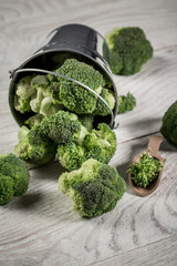 Bowl with fresh green broccoli on table. Healthy Green Organic Raw Broccoli. vertical image
