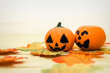 Halloween pumpkins with painted faces on a wooden table. Halloween background. Space for text. copy space.