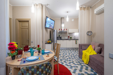 Modern interior of light studio apartment. Living room and kitchen.