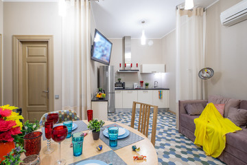 Modern interior of light studio apartment. Living room and kitchen.