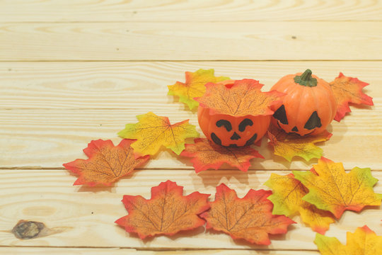 Halloween pumpkins with painted faces on a wooden table. Halloween background. Space for text. copy space. Halloween concept