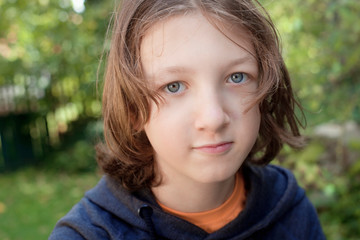 Portrait of a Boy with Brown Hair Outdoors.