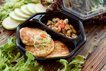 Zucchini pancakes with fried mushrooms. Take with you. Food delivery. Useful sports nutrition. Detox