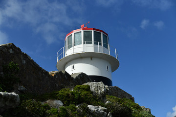 sea lighthouse on a background of blue sea