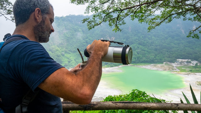 Man drinking Mate at Laguna de Alegria at the Tecapa volcano, El Salvador
