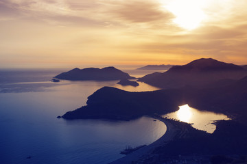 Seascape with mountain silhouettes at sunset.  Turkish Oludeniz Beach, aerial view from the mountain