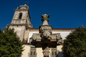 Fototapeta na wymiar Fountain And Church Tower, Tibaes Monastery, Portugal