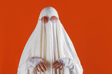 Happy Halloween. Cute funny Ghost on a bright orange background