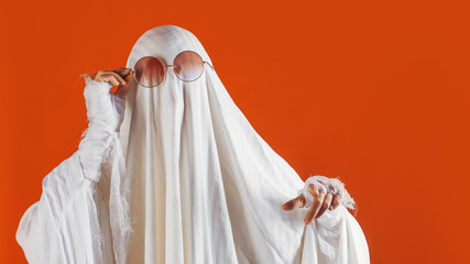 Happy Halloween. Cute funny Ghost on a bright orange background