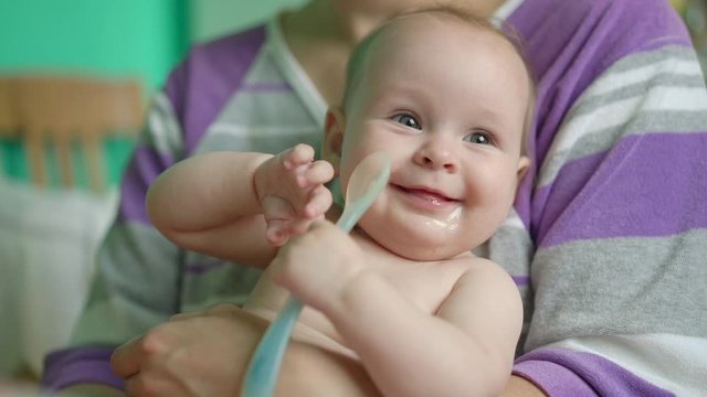 Adorable baby with spoon in mouth