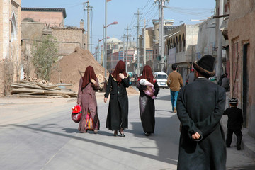 Three Uyghur Madonnas on the street of old town. Kashgar, Xinjiang, China, Asia.