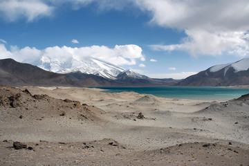 Mountainous landscape. View at Muztagh Ata Peak (7546 m) and Karakul Lake. Pamir mountains,...