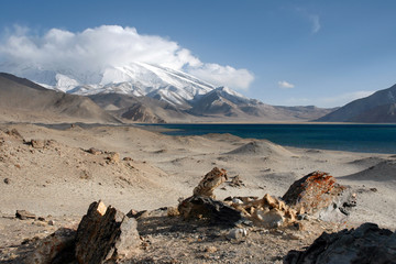 Mountainous landscape. View at Muztagh Ata Peak (7546 m) and Karakul Lake. Pamir mountains, outskirts of Kashgar, Xinjiang, China, Asia.