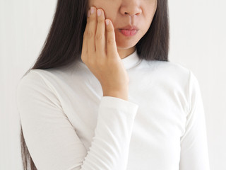 trigeminal neuralgia and temporomandibular joint and muscle disorder in asian woman, She use hand...