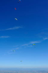 Paragliders in full flight over volcanoes of Puy de Dome