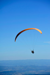 Paragliders in full flight over volcanoes of Puy de Dome