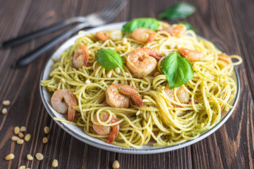 Spaghetti seafood pasta with prawns and basil. Pasta with pesto and prawns.