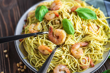 Spaghetti seafood pasta with prawns and basil. Pasta with pesto and prawns.