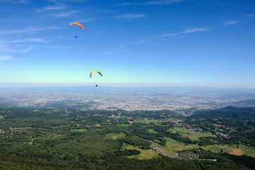 Paragliders in full flight over volcanoes of Puy de Dome