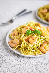 Spaghetti seafood pasta with prawns and basil. Pasta with pesto and prawns.