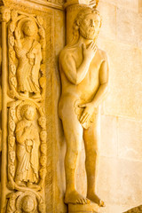 Statue of Adam at the entrance to the cathedral of Saint Lawrence in Trogir, Croatia