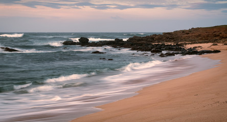 Long exposure of waves crashing on a beach.  Image taken on the island of Molokai, Hawaii