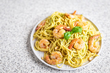 Spaghetti seafood pasta with prawns and basil. Pasta with pesto and prawns.