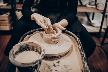 master makes a vase of clay, clay circle, close-up hands, mug of raw clay, hands made