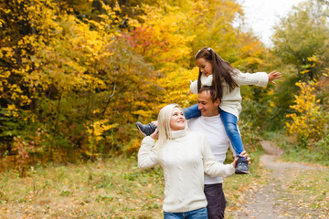Family with child go in autumn park