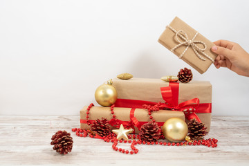 Woman's hands hold christmas or new year decorated gift box