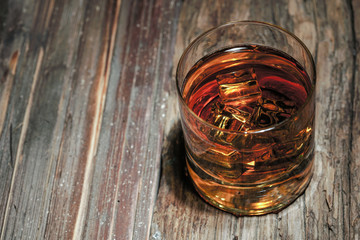 glass of whiskey on wooden