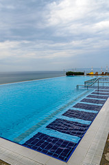 Infinity pool with crystal blue water view to sea  ocean