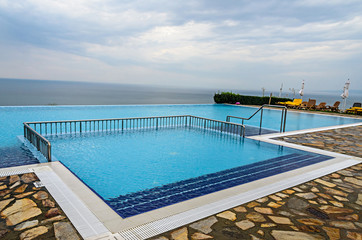Infinity pool with crystal blue water view to sea  ocean