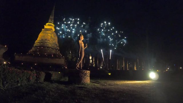 Buddha stand and Fireworks and amazing Loi Kra Tong festival at Sukhothai historical park Thailand