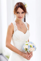 Portrait of bride with fascinating look in white dress.