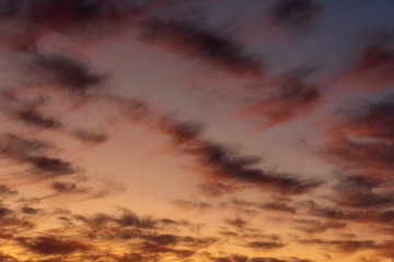 Obraz premium Sunset with cloudy sky, cirrus clouds, blues, oranges, yellows and pinks, nature background