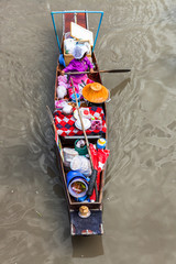 Women with straw hat in old wooden canoe on amphawa floating market in thailand near bangkok shot...