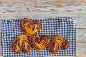 Cinnamon roll on a light wooden background.