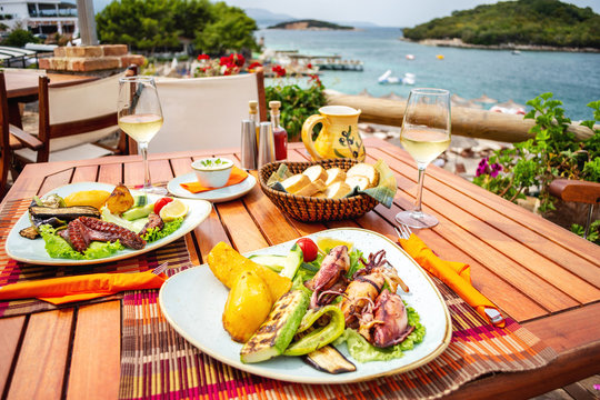 Grilled seafood stuffed with vegetables and lemon on the table in seafront