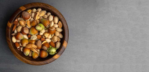 banner of nuts mix in a wooden bowl, snack rich with vitamin E