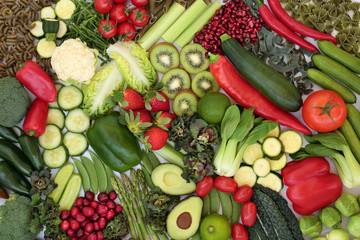 Vegan health food collection with plant based green and red foods of fruit & vegetables and pasta. High in vitamins, minerals, antioxidants, anthocynins, fibre and smart carbs. Flat lay.