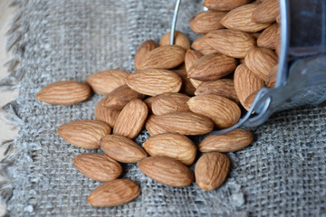 Almonds spilling out of a metallic bucket