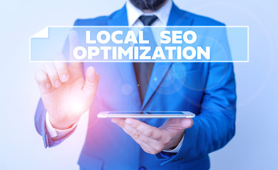 Handwriting text Local Seo Optimization. Conceptual photo increase Search Visibility to Rank on Top list Businessman with pointing finger in front of him