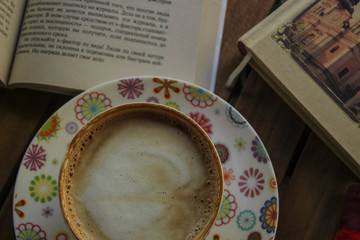 coffee and book on a wooden table