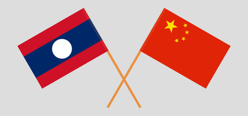 Laos and China. Crossed Laotian and Chinese flags