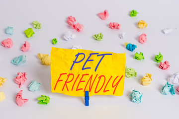 Word writing text Pet Friendly. Business photo showcasing used to describe a place that is suitable or allowed for pets Colored crumpled papers empty reminder white floor background clothespin