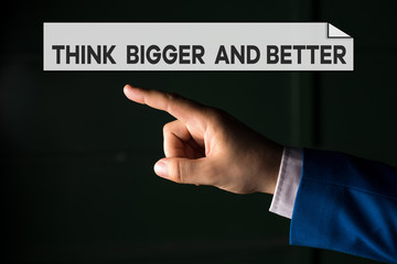 Writing note showing Think Bigger And Better. Business concept for no Limits be Open minded Positivity Big Picture Isolated hand pointing with finger. Business concept pointing finger