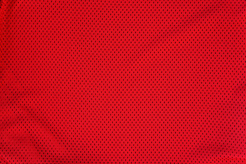 Textured bright red mesh fabric. Folds