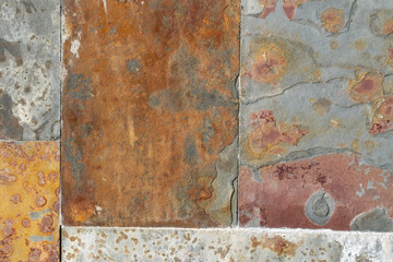 Old wall of damaged blocks with textural rust and corrosion. Colorful abstract background