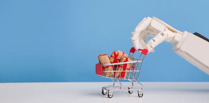 Robot hand with shopping cart full of gift boxes, blue background